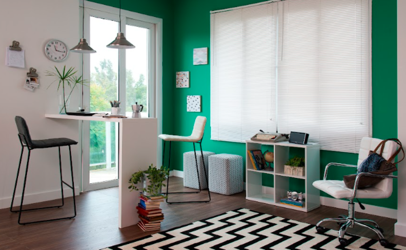cantinho da leitura na sala com quadros decorativos, poltrona, integrado com um balcão da cozinha e banqueta