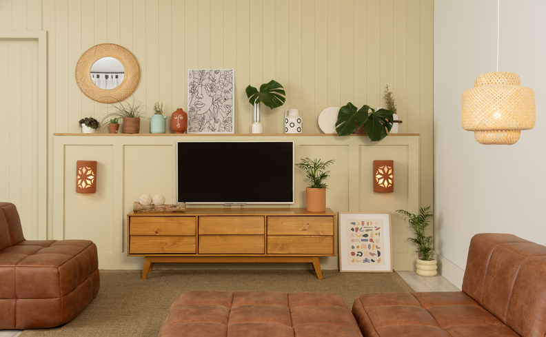 lista de casa nova com móveis indispensáveis como rack, sofá e uma prateleira para manter tudo organizado e prático na sala de estar.